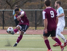 male soccer player kicks ball 
